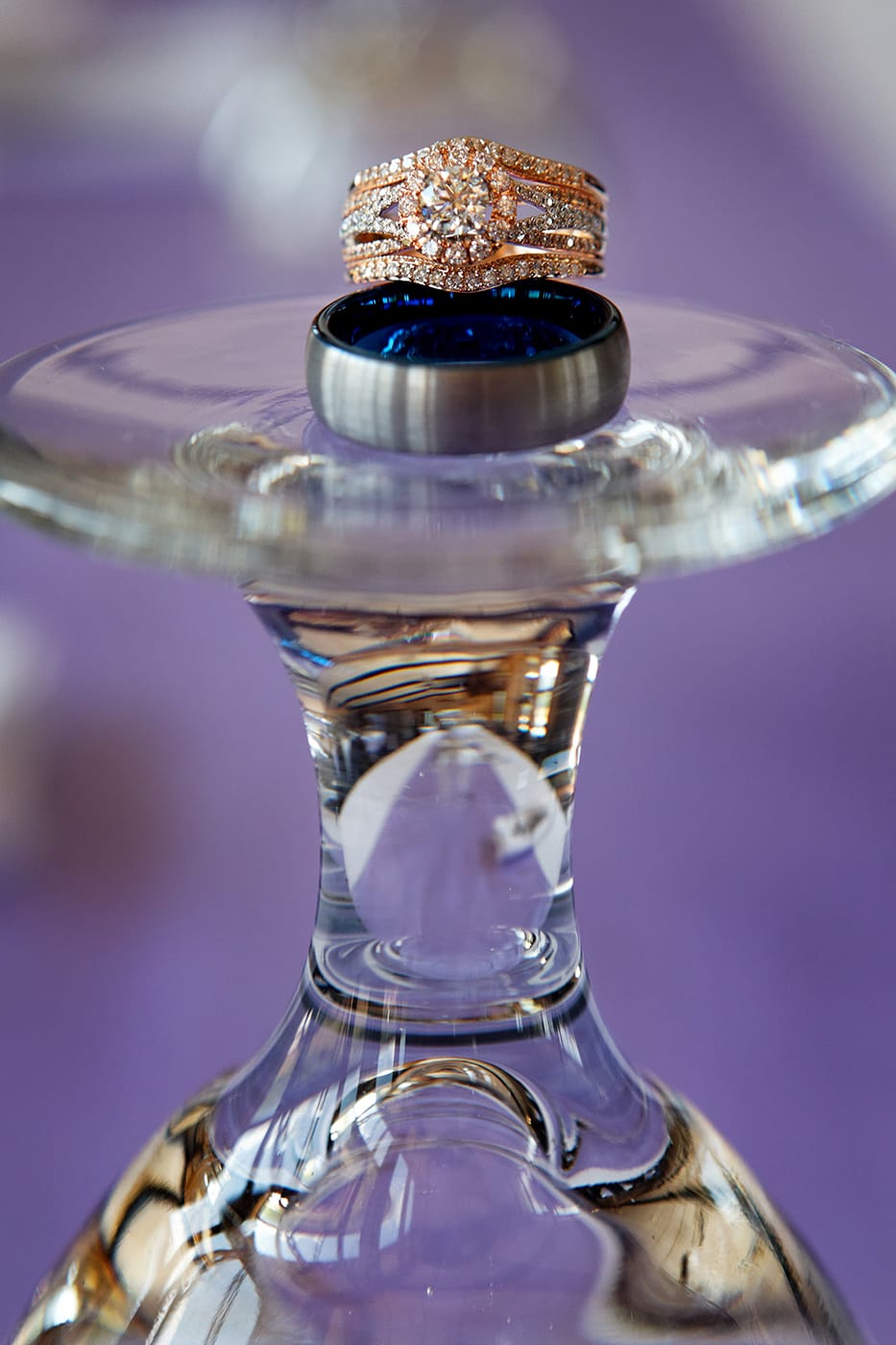 bride's and groom's ring on a water glass