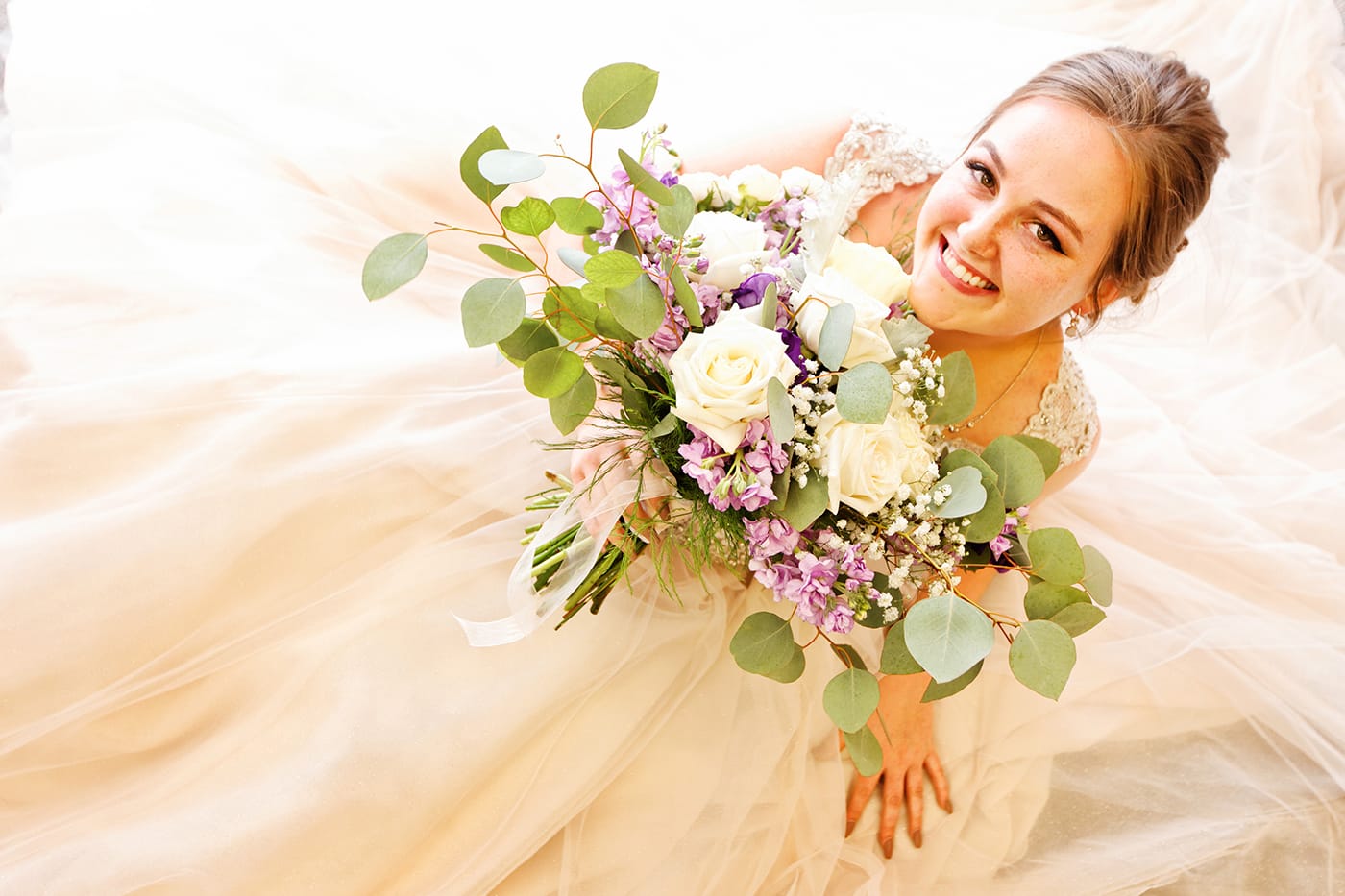 bride smiling with her bouquet